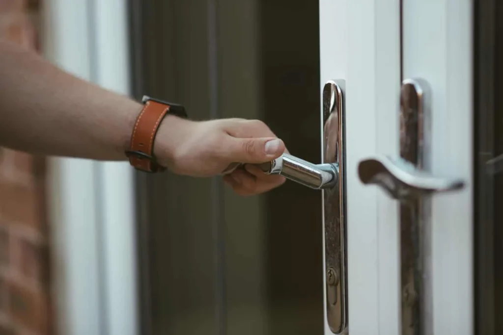 Fort Worth residential locksmith inspecting water-damaged lock during rain season