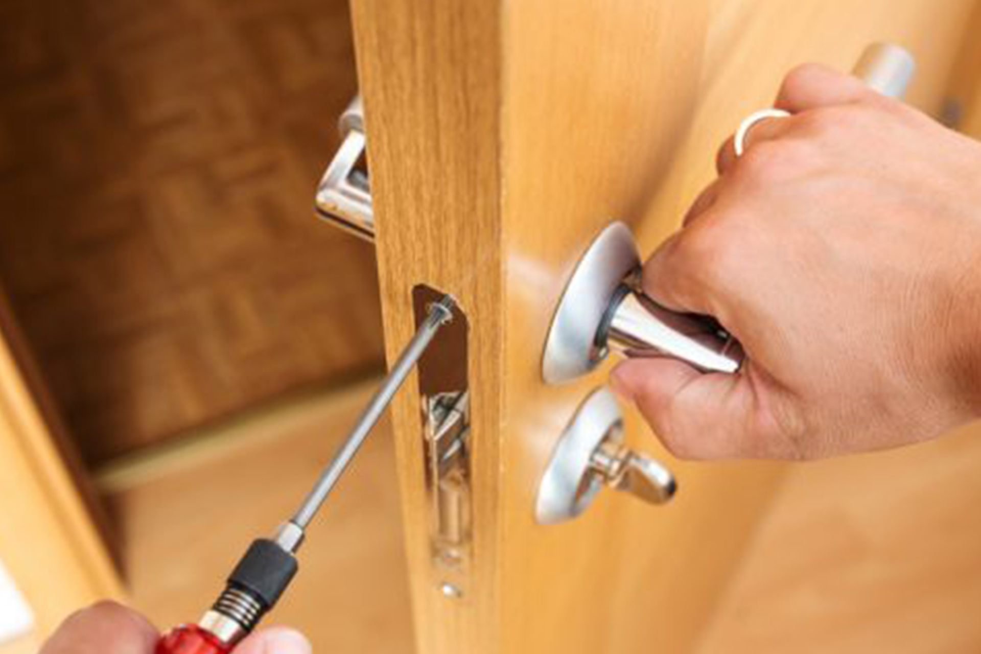Common residential door lock problems being fixed by a locksmith
