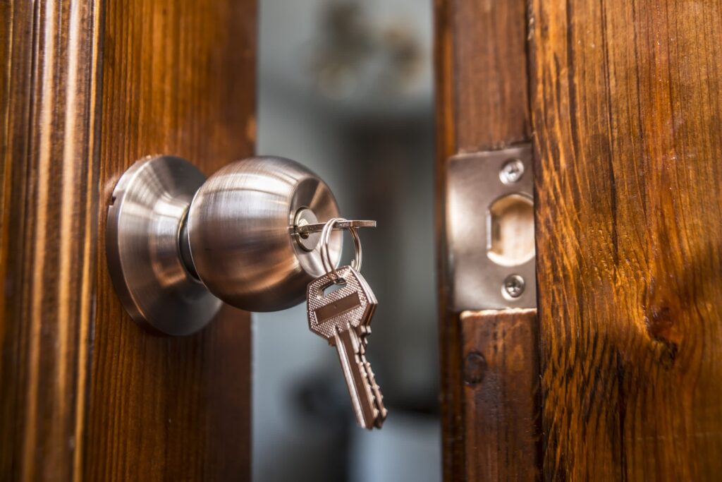 Fort Worth locksmith replacing residential house keys on a front door.