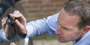 Driver checking car key fob and door lock before Thanksgiving road trip