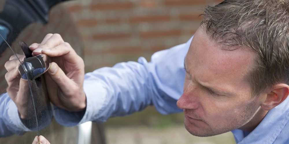 Driver checking car key fob and door lock before Thanksgiving road trip