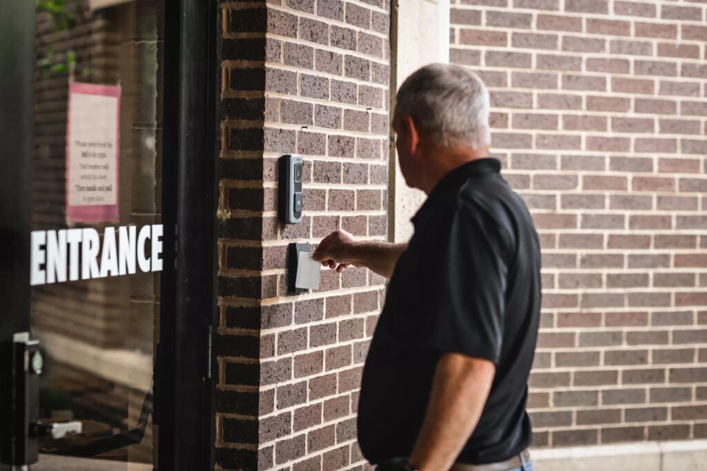 Electronic access control keypad and smart lock on a retail backdoor representing temporary access solutions